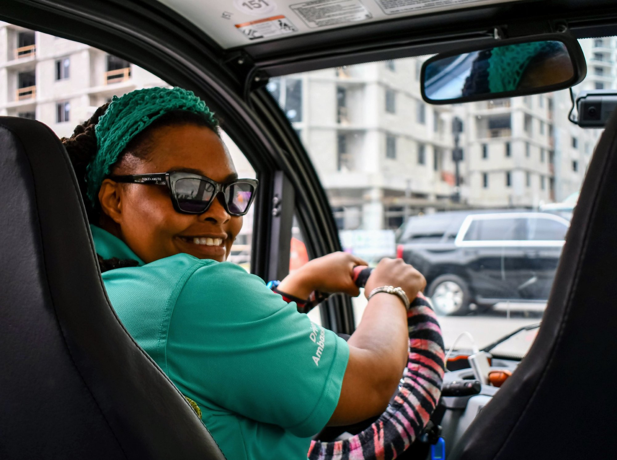 Employee_driver_looking_back_smiling Employee_driver_looking_back_smiling